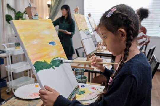 A student paints a picture in art class.