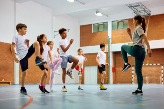 Group of elementary students have PE class.