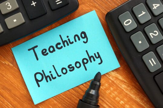 A Post-It note that has the phrase "teaching philosophy" written on it.