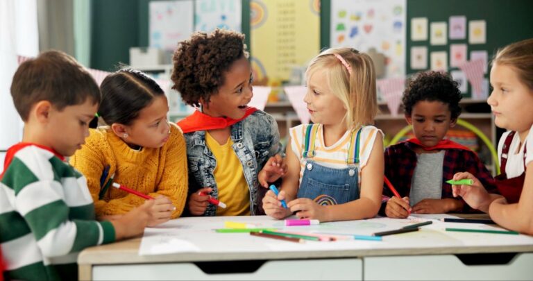 A group of students work together on making a poster.